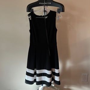 Classic A line with belt. Very comfortable worn with a white cropped sweater